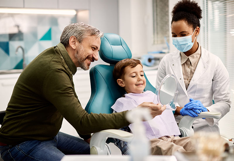 Central Dental Family - Dentist talking to a family about dentistry