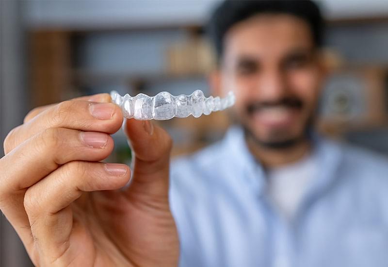 Central Dental Family - Patient holding their Invisalign